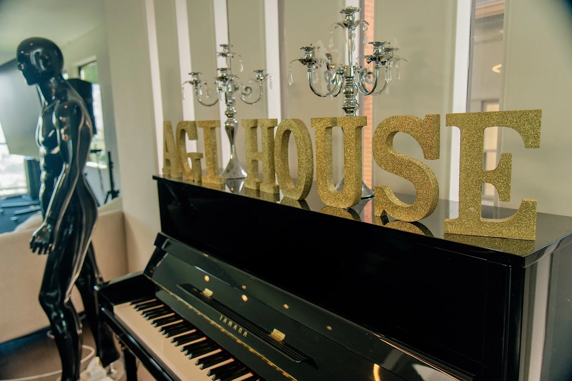 The AGI House sign above the piano in the main room